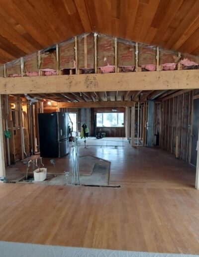 A living room is being remodeled with wood flooring.