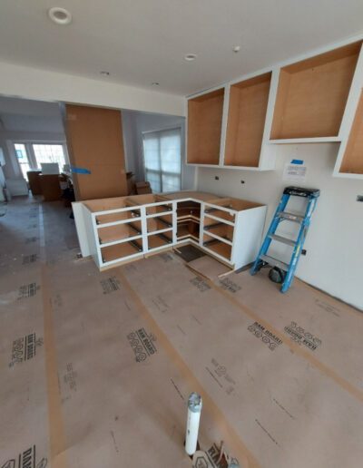 A kitchen with shelves and a ladder.