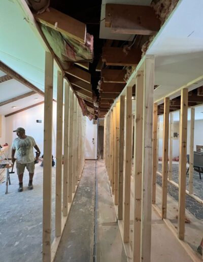 A man is working in a room that is being framed.