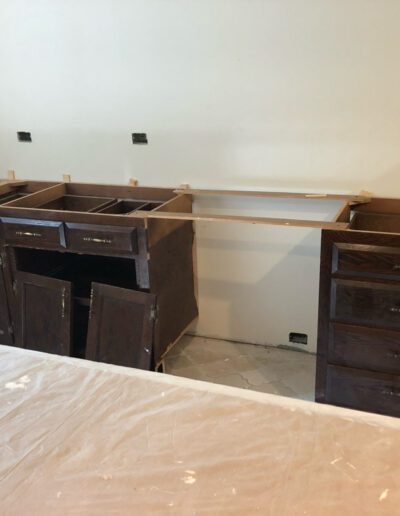 A kitchen with drawers and cabinets.