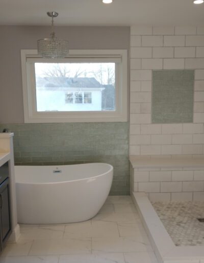 A white bathroom with a tub and sink.