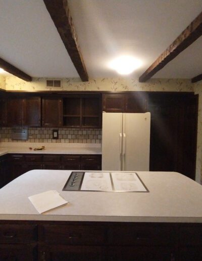 A kitchen with brown cabinets and a white counter top.