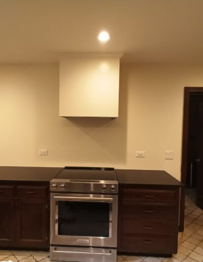 An empty kitchen with a stove and oven.