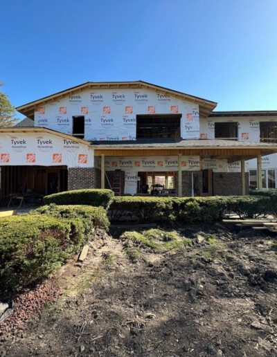 A house under construction with shingles and siding.