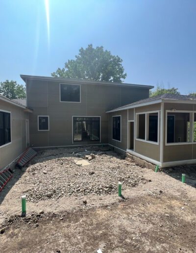 A home under construction with a large front porch.