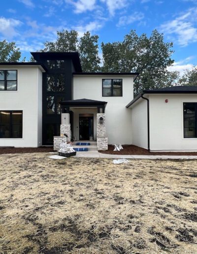 The exterior of a home is being painted in black and white.