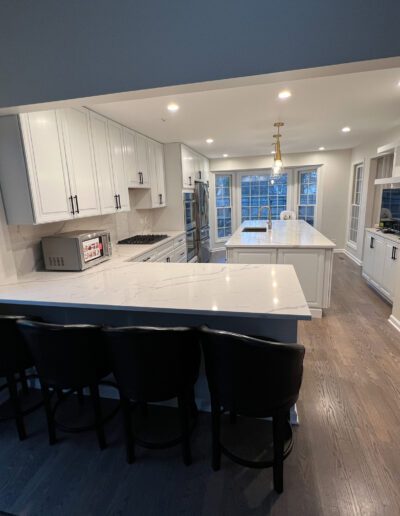 A kitchen with a large island and bar stools.