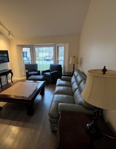 A living room with a couch, coffee table and tv.