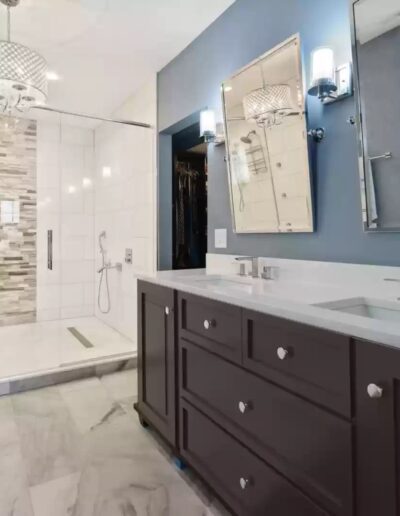 A bathroom with blue walls and a large mirror.