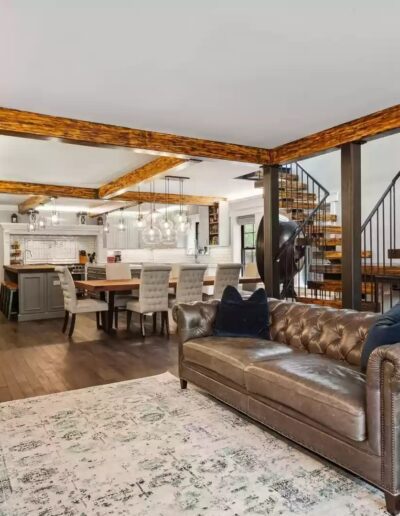 A living room with hardwood floors and a staircase.