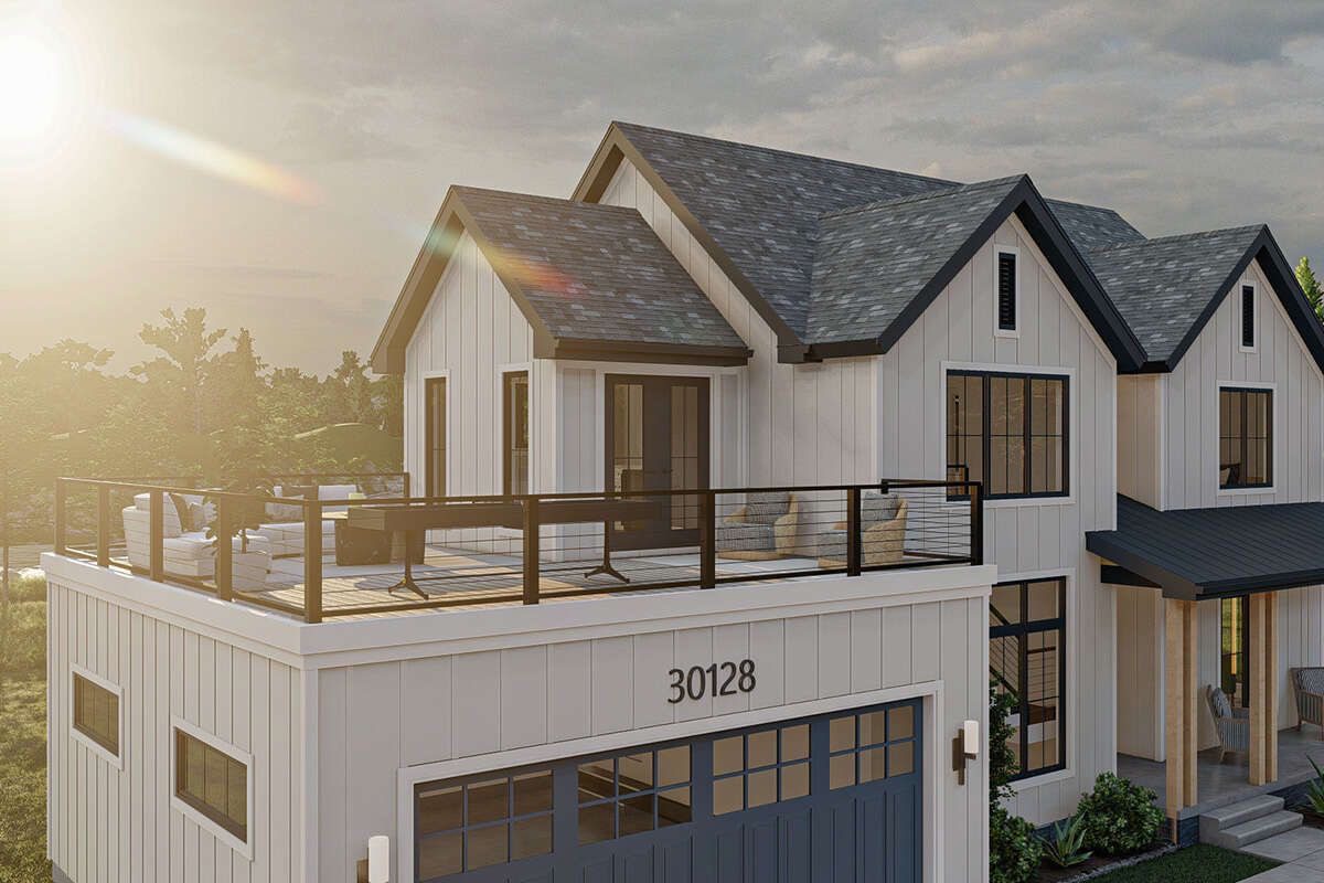 Modern white two-story house with a rooftop terrace, large windows, and a garage. Sunlight shines from the left, casting a warm glow.