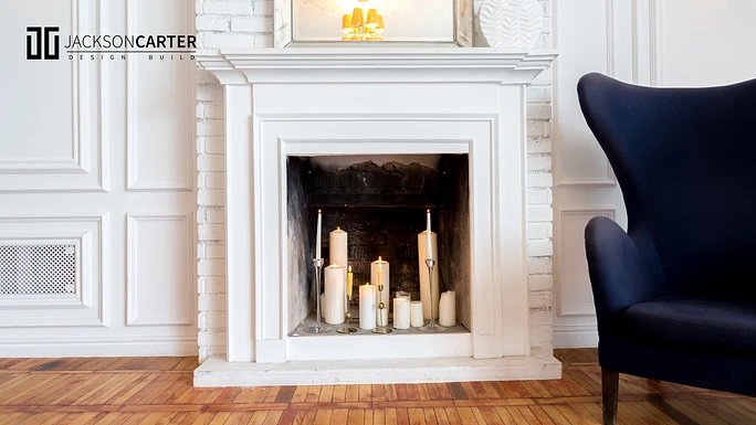 arrangement of candles at empty fireplace